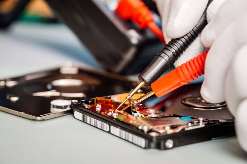 closeup-gloved-hands-repairing-technology-with-tools