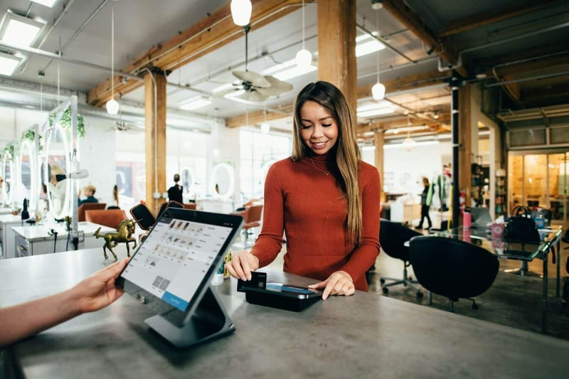 woman-consumer-checking-out-at-retail-point-of-sale-system